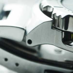 Detailed close-up of a metallic watch band showcasing modern and shiny design elements.