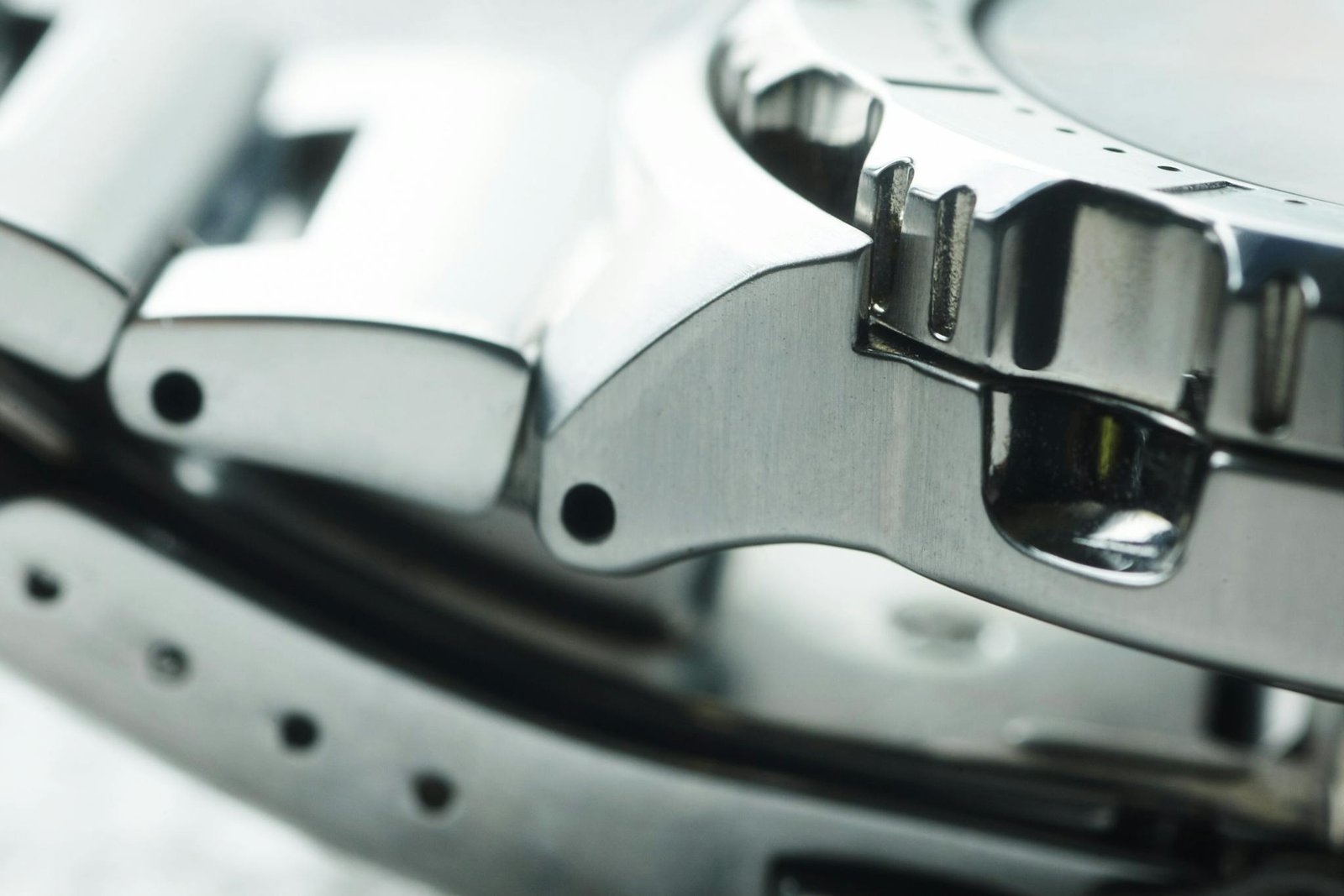 Detailed close-up of a metallic watch band showcasing modern and shiny design elements.